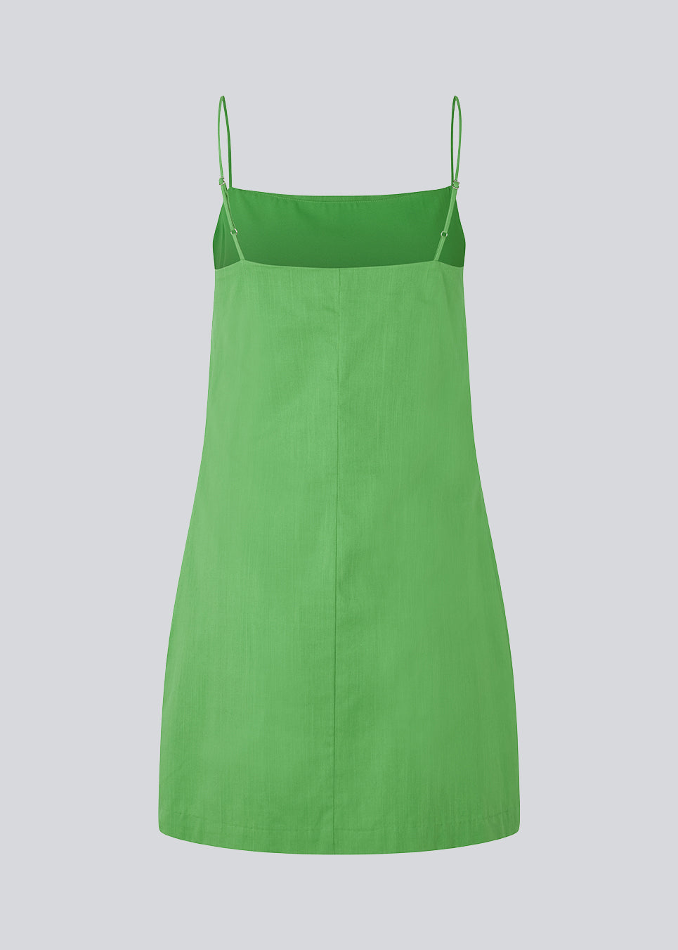 Short dress in green with a clean look in woven cotton. CydneyMD dress is slightly tailored, has adjustable straps, and a hidden zipper on one side. The model is 174 cm and wears a size S/36.