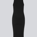 Tight fitted basic black dress in organic cotton jersey. DaeMD dress is sleeveless with a high and straight neckline. The dress cuts below the knees. The model is 177 cm and wears a size S/36.