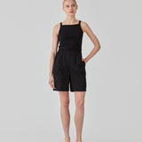 Tight fit basic black top with a high and straight neckline. DaeMD top is made from a rib-knitted organic cotton. The model is 177 cm and wears a size S/36.