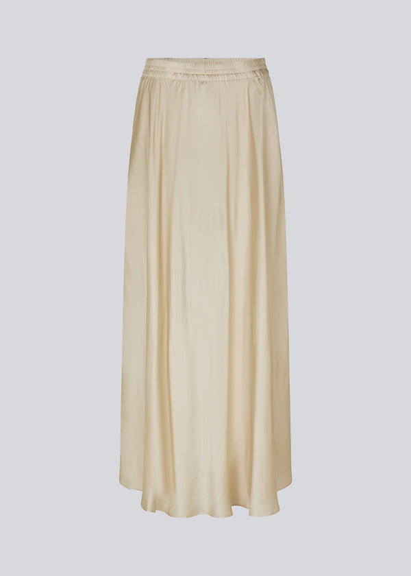 Long white skirt with wide skirt. DevanMD skirt is designed in a shiny satin material with elasticated medium waist.
