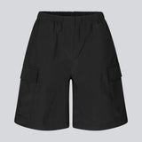 Cargo shorts in black in nylon with wide legs. DilaraMD shorts have an elasticated waistband and two large patch pockets on the sides. The model is 177 cm and wears a size S/36.