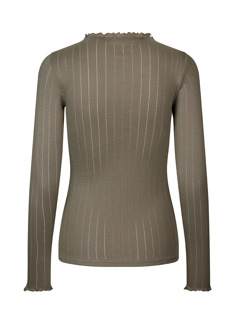 Tight fitted t-shirt in brown with a medium high neck. Issy t-neck has feminine lettuce hem on neck and sleeves. The quality is a soft jersey with a feminine pointelle pattern.