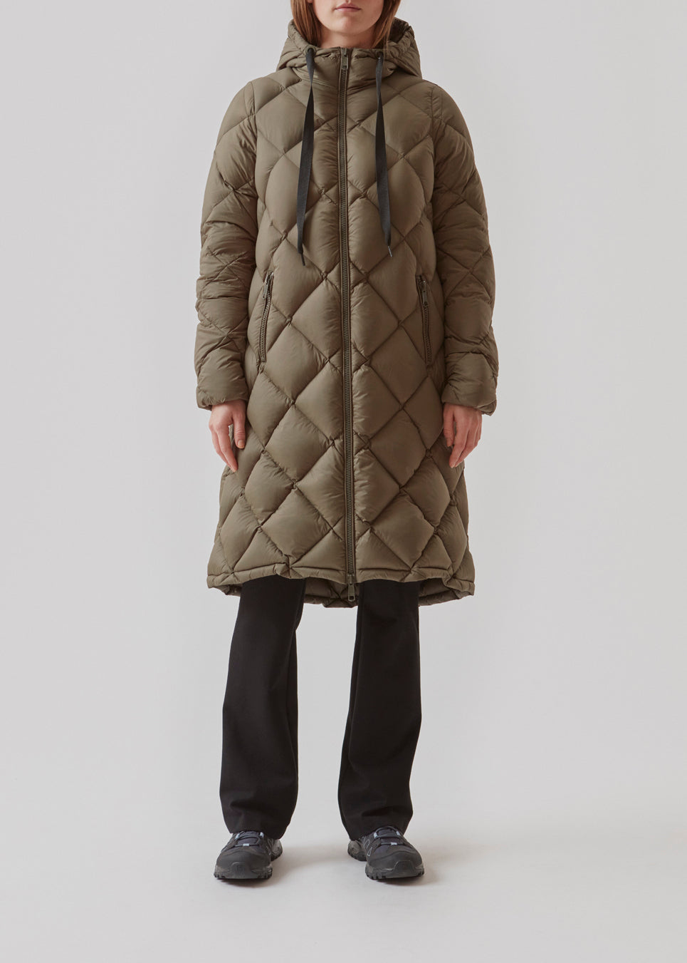 Smart down coat in a diamond quilt in dark green. The coat has a hood with adjustable strings and two zipped pockets. Kyra coat has a down filling, which gives an outstanding insulation from the cold - even on the coldest days. Keep you warm down to -15 degrees. It’s water repellant, wind resistant