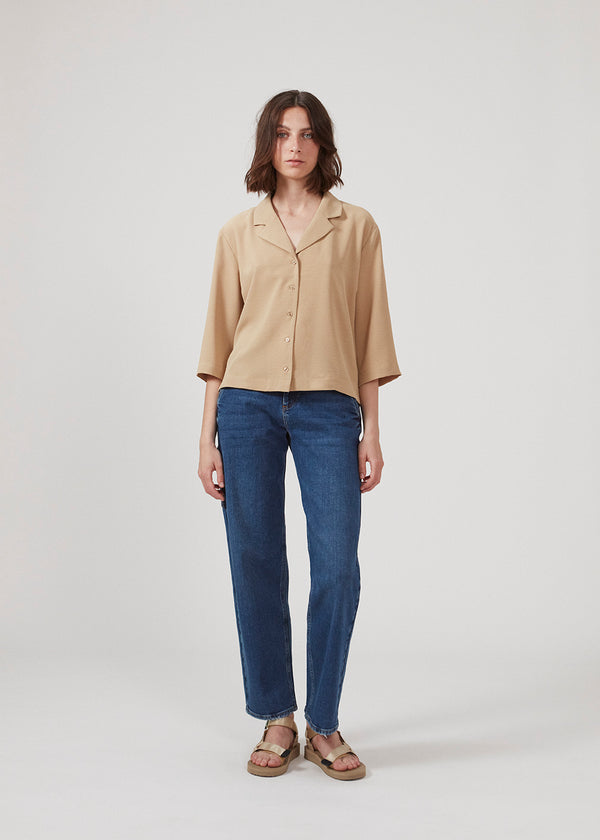 Shirt in beige in a relaxed silhouette and 3/4 length sleeves. AaliyahMD shirt has a resort collar, dropped shoulders and button closure in front.