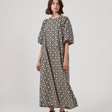 Long dress with a wide skirt and voluminous puff sleeves. CoraMD print dress has a round neck with a cut out and bow in the back. Made from organic cotton.  The model is 174 cm and wears a size S/36.