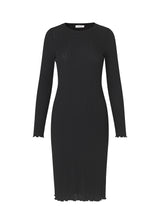 Form-fitted dress in a soft quality. Oasis dress has elegant long sleeves, a round neck, and a length that cuts just below the knee. Edges are ruffled for a beautiful finish.