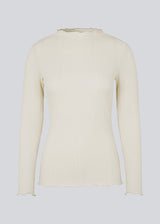 Tight-fitted, beige long sleeved t-shirt with ruffled trimmings on sleeves, at the neck and bottom. Oasis t-neck fits perfectly as a basic style in the wardrobe. 