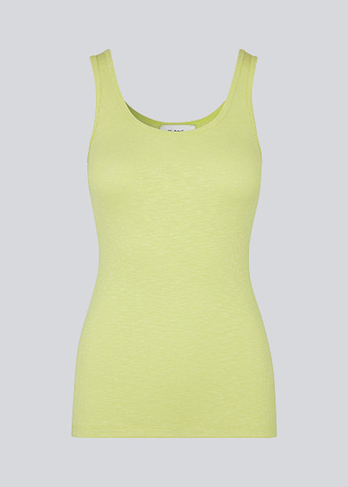 Olla top in yellow is a simple tanktop in a soft rib material. The top has a tight and figure-hugging silhouette which has a soft feel under a knitted sweater or shirt. The model is 173 cm and wears a size S/36.