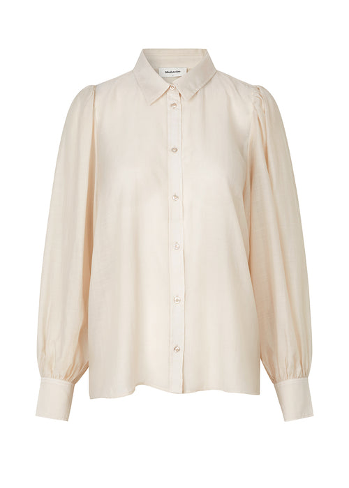 Classic shirt in a light and airy material. Oskar shirt has a relaxed fit with voluminous balloon sleeves finished with a wide cuff. The shirt is a bit sheer for an ultra feminine expression.