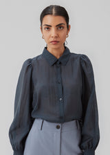 Classic shirt in dark blue in a light and airy material. Oskar shirt has a relaxed fit with voluminous balloon sleeves finished with a wide cuff. The shirt is a bit sheer for an ultra-feminine expression. The model is 174 cm and wears a size S/36.