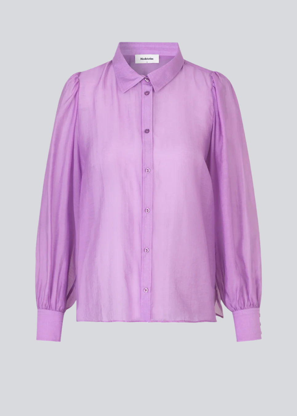 Classic shirt in a purple, light and airy material. Oskar shirt has a relaxed fit with voluminous balloon sleeves finished with a wide cuff. The shirt is a bit sheer for an ultra-feminine expression.