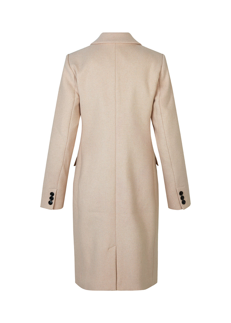 Beautiful, long wool coat in beige. Pamela coat is closed by 3 big buttons at front and is waisted, which gives a feminine look. Because of the high content of wool you will be able to keep warm all through fall and the mild winters.