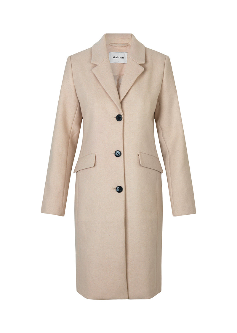 Beautiful, long wool coat in beige. Pamela coat is closed by 3 big buttons at front and is waisted, which gives a feminine look. Because of the high content of wool you will be able to keep warm all through fall and the mild winters.