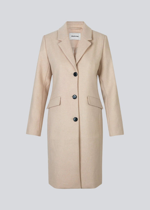 Beautiful, long wool coat in beige. Pamela coat is closed by 3 big buttons at front and is waisted, which gives a feminine look. Because of the high content of wool you will be able to keep warm all through fall and the mild winters.