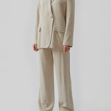 Blazer in a voluminous fit with an asymmetrical look. Park blazer in Cream Milk is made from an airy linen quality, which is easy to style with the matching pants or over a dress on a summer evening.