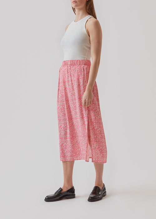 Airy, long skirt in pink print. The skirt has elastic at the waist and a slit at the side. Use the skirt, RinnaMD print skirt for everyday or party.  Buy matching RinnaMD print top in the same color and print.