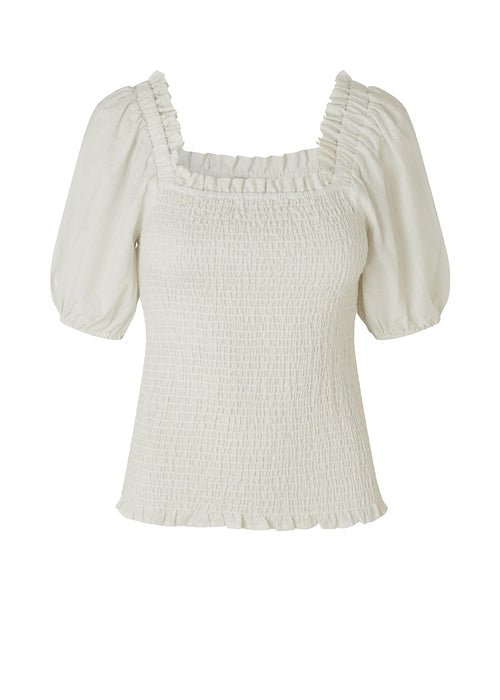 Top in white in a snug fit made from a light cotton with smock bodice. RonaldMD top has a square neckline with a small frilled trim. The sleeves are short and voluminous.