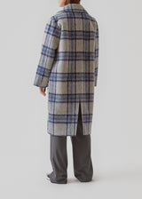 Coat in a soft, checked wool material with a relaxed fit and long, voluminous sleeves. In the color Blue Pearl Check. SallieMD check coat is calf-length, and has a collar and notch lapels with buttons down the front. Side pockets and single back vent. Lined.