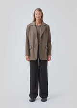 Blazer in brown with an oversized silhouette in a wool weave. SonnyMD jacket has a collar and notch lapels with two buttons in front and flap front pockets. Slit at sleeves and vent in back. Lined.