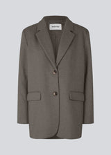Blazer in brown with an oversized silhouette in a wool weave. SonnyMD jacket has a collar and notch lapels with two buttons in front and flap front pockets. Slit at sleeves and vent in back. Lined.