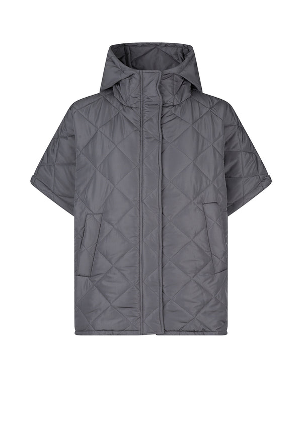 Oversized, quilted poncho with hood in a padded, more responsible material. SophiaMD poncho has deep armholes with press-studs at sides and front. Paspel pockets.