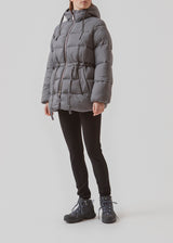 Puffer jacket in grey with an oversized silhouette and adjustable drawstring waist. StellaMD jacket is designed with a high-standing collar, hood, two-way zipper and paspel pockets.