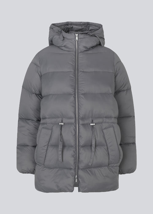 Puffer jacket in grey with an oversized silhouette and adjustable drawstring waist. StellaMD jacket is designed with a high-standing collar, hood, two-way zipper and paspel pockets.
