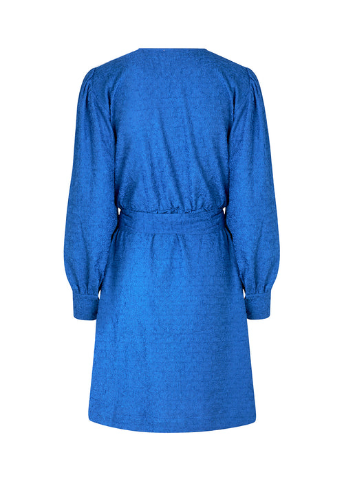 Short dress with wrap detail, tiebelt at the waist, and v-neckline. TalissaMD wrap dress has long puffsleeves with cuff. Designed in a structured material.