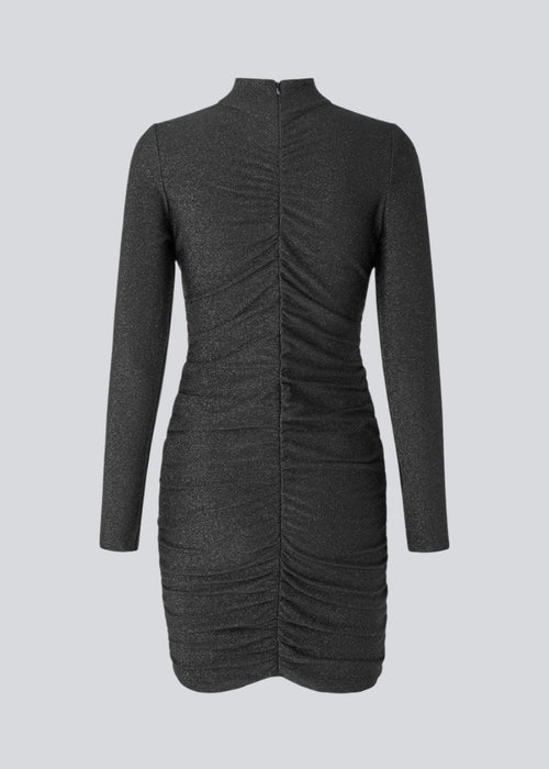 Short dress with long sleeves and low collar. TamilMD dress is designed with a slim shape with a wrinkled, elastic detail down the center front and center back.