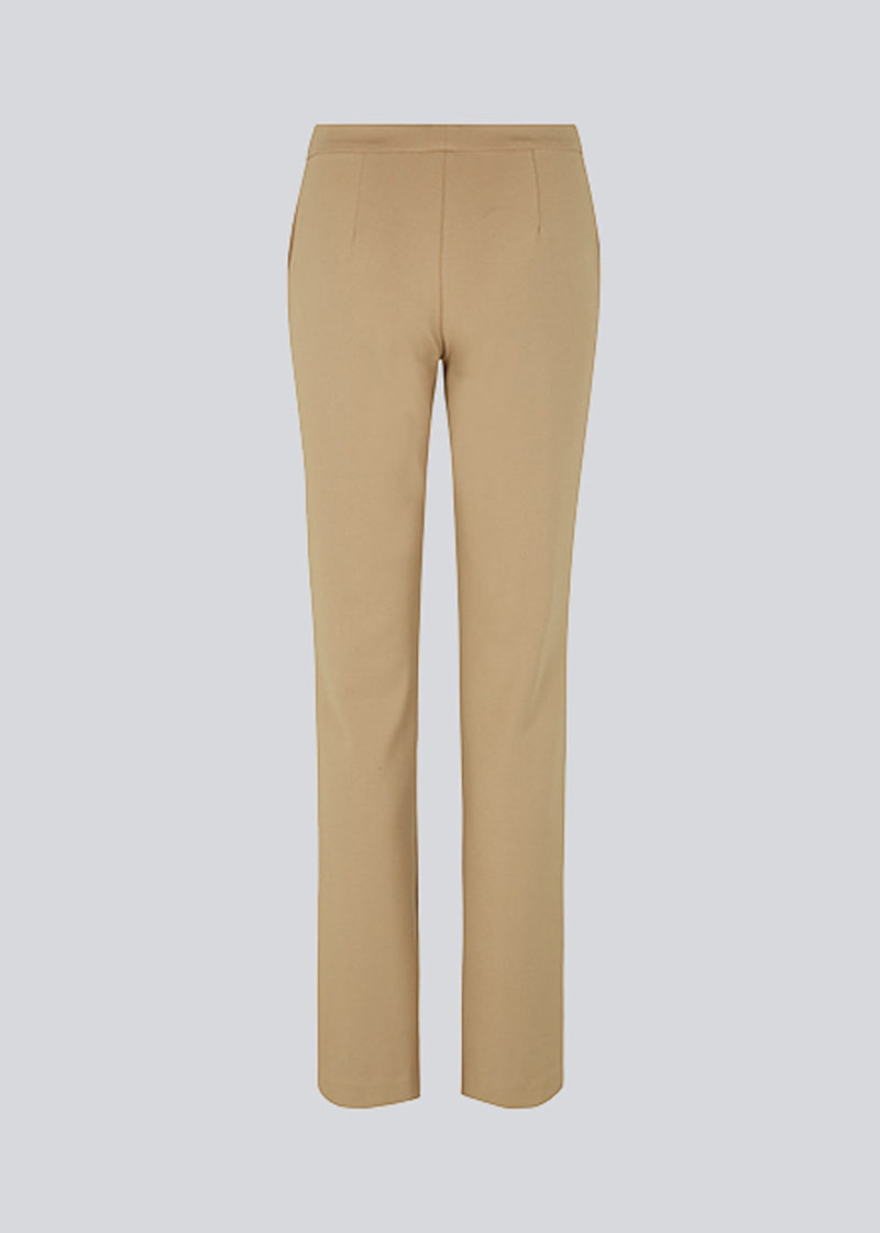 Nice beige pants with flared legs and front pockets. The stretchy material and elastic waist creates the perfect fit. 