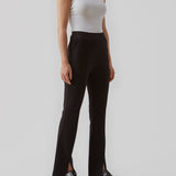 Nice pants in a soft quality with stretch. Tanny slit pants has a simple design with an elasticated waistline and a tight fit. The slit detail at the hem creates more width and effect at the bottom.