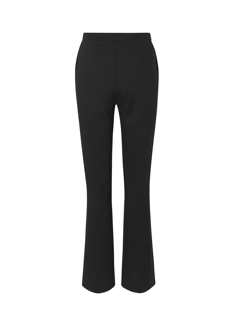 Nice pants in a soft quality with stretch. Tanny slit pants has a simple design with an elasticated waistline and a tight fit. The slit detail at the hem creates more width and effect at the bottom.