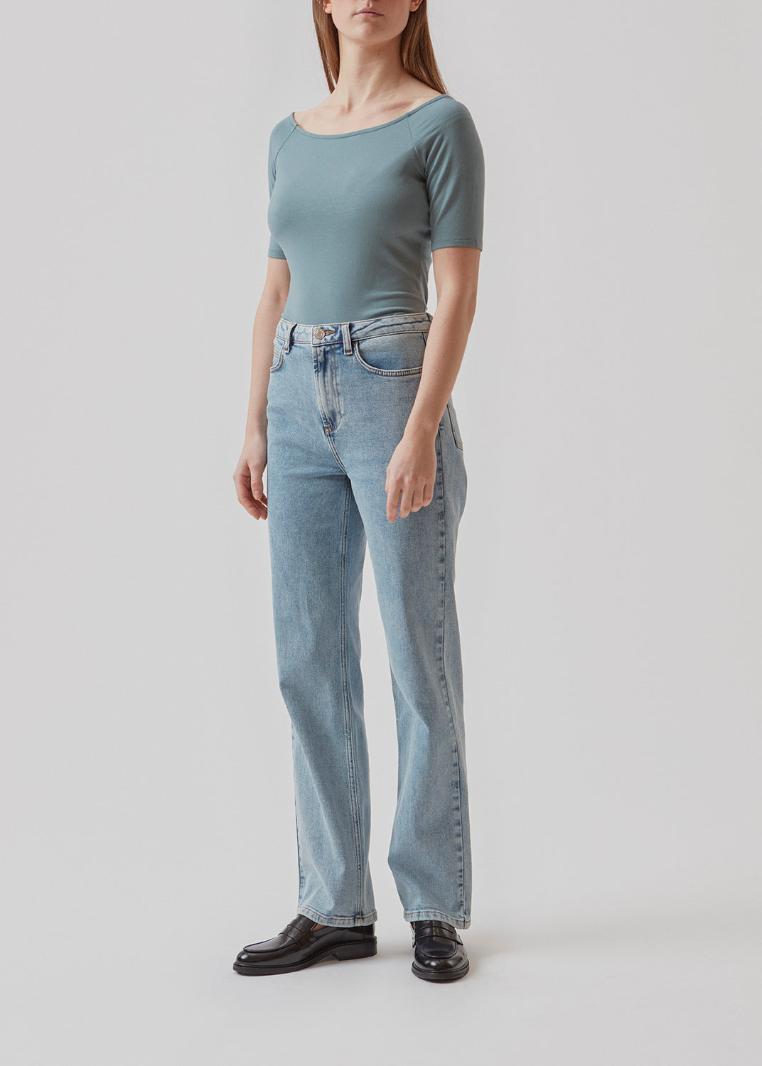 Tansy top in the color stormy sea has a simple look with a wide neckline at front and back and narrow sleeves. The top is slim fit without being tight. The model is 174 cm and wears a size S/36