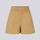 Shorts in a light, organic cotton poplin. TapirMD shorts have a high waist with elasticated waistband and short, wide legs. Pockets at side seam and a short slit at sides.  Material: 100% Organic Cotton