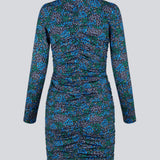 Short dress in the color Malibu Poerty Flower, with long sleeves and low collar. TilloMD print dress is designed with a slim shape with a wrinkled, elastic detail down the center front and center back.