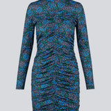 Short dress in the color Malibu Poerty Flower, with long sleeves and low collar. TilloMD print dress is designed with a slim shape with a wrinkled, elastic detail down the center front and center back.