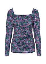 Floral top with long sleeves and wide neckline in front and back. TilloMD print top is made from a stretchy material with elasticated detail down the center front.