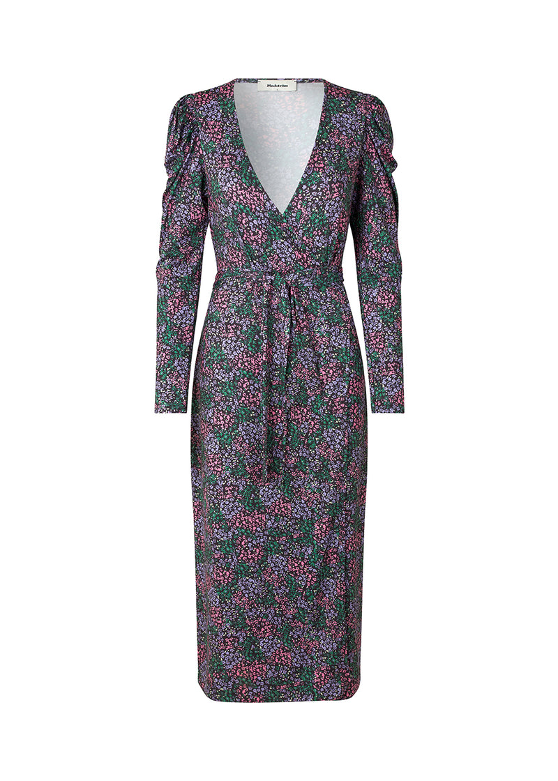 Wrap dress with gigot sleeves and a v-shaped neckline. TilloMD print wrap dress is designed in a stretchy material writh wrap-detail and a belt at the waist.