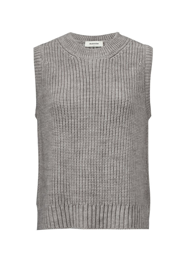 Cool and classic knitted vest with structure. Timme vest has rib edge at neck and bottom and has a loose fit. Style the vest over a t-shirt or a dress for a feminine look.