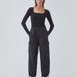 Cargo pants in nylon with elastic waistline and adjustable hems with elastic drawstrings. TrentMD pants have patch pockets on the legs. In black.  This is the same model as our popular pants AmayaMD pants. Just in a thicker material, perfect for fall and winter. 