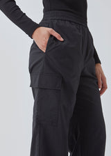 Cargo pants in nylon with elastic waistline and adjustable hems with elastic drawstrings. TrentMD pants have patch pockets on the legs. In black.  This is the same model as our popular pants AmayaMD pants. Just in a thicker material, perfect for fall and winter. 