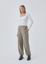 Cargo pants in nylon with elastic waistline and adjustable hems with elastic drawstrings. TrentMD pants have patch pockets on the legs. In Spring Stone.  This is the same model as our popular pants AmayaMD pants. Just in a thicker material, perfect for fall and winter. 