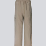 Cargo pants in nylon with elastic waistline and adjustable hems with elastic drawstrings. TrentMD pants have patch pockets on the legs. In Spring Stone.  This is the same model as our popular pants AmayaMD pants. Just in a thicker material, perfect for fall and winter. 