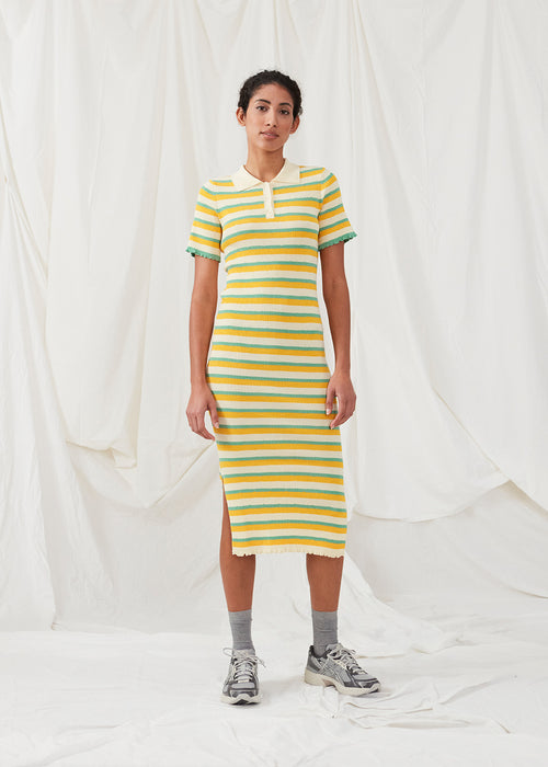  Tight fit long dress in a stretchy quality with stripes. DorisMD dress features a polo collar with buttons, short sleeves, and lettuce hems. The model is 177 cm and wears a size S/36.