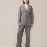 Slim-fitted blazer in grey with voluminous sleeves and soft shoulders. BennyMD blazer features buttons, pospoil pockets, a collar, and a notch lapel. No slit on the back.  Match with pants: BennyMD pants.