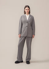 Slim-fitted blazer in grey with voluminous sleeves and soft shoulders. BennyMD blazer features buttons, pospoil pockets, a collar, and a notch lapel. No slit on the back.  Match with pants: BennyMD pants.
