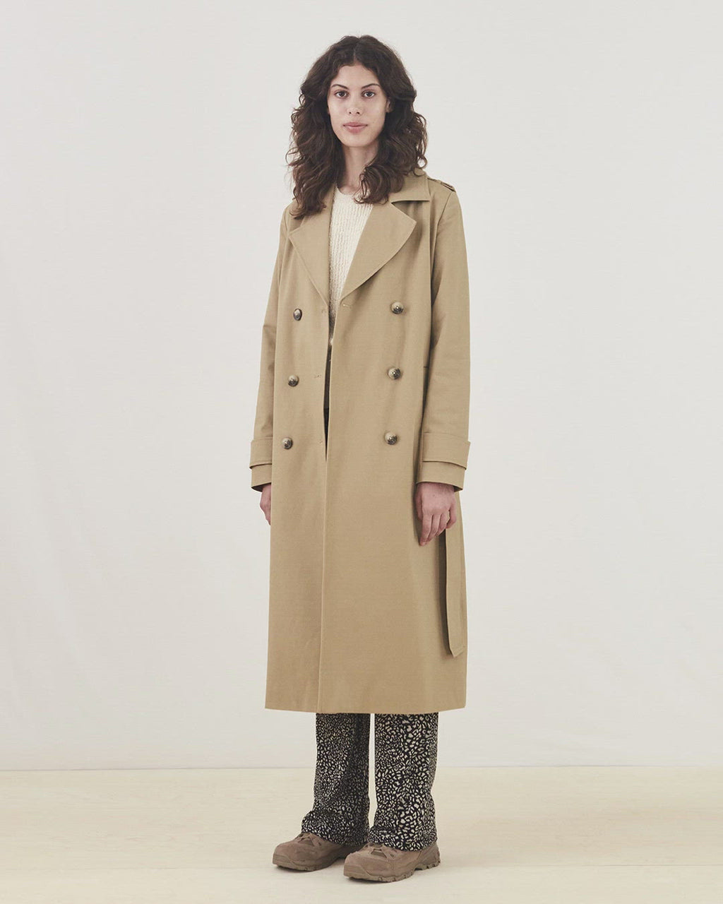 Classic trenchcoat in a rich cotton quality. Oak jacket is double-breasted, with revers, and a slit at the back. The wide belt and cuff adds extra details to the recognizable silhouette. The model is 173 cm and wears a size S/36